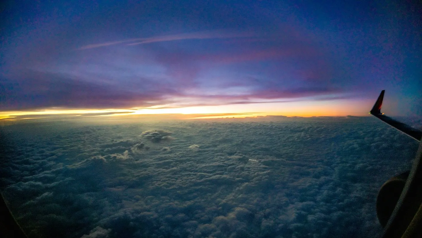 Sunset over the cloud deck from an airplane window