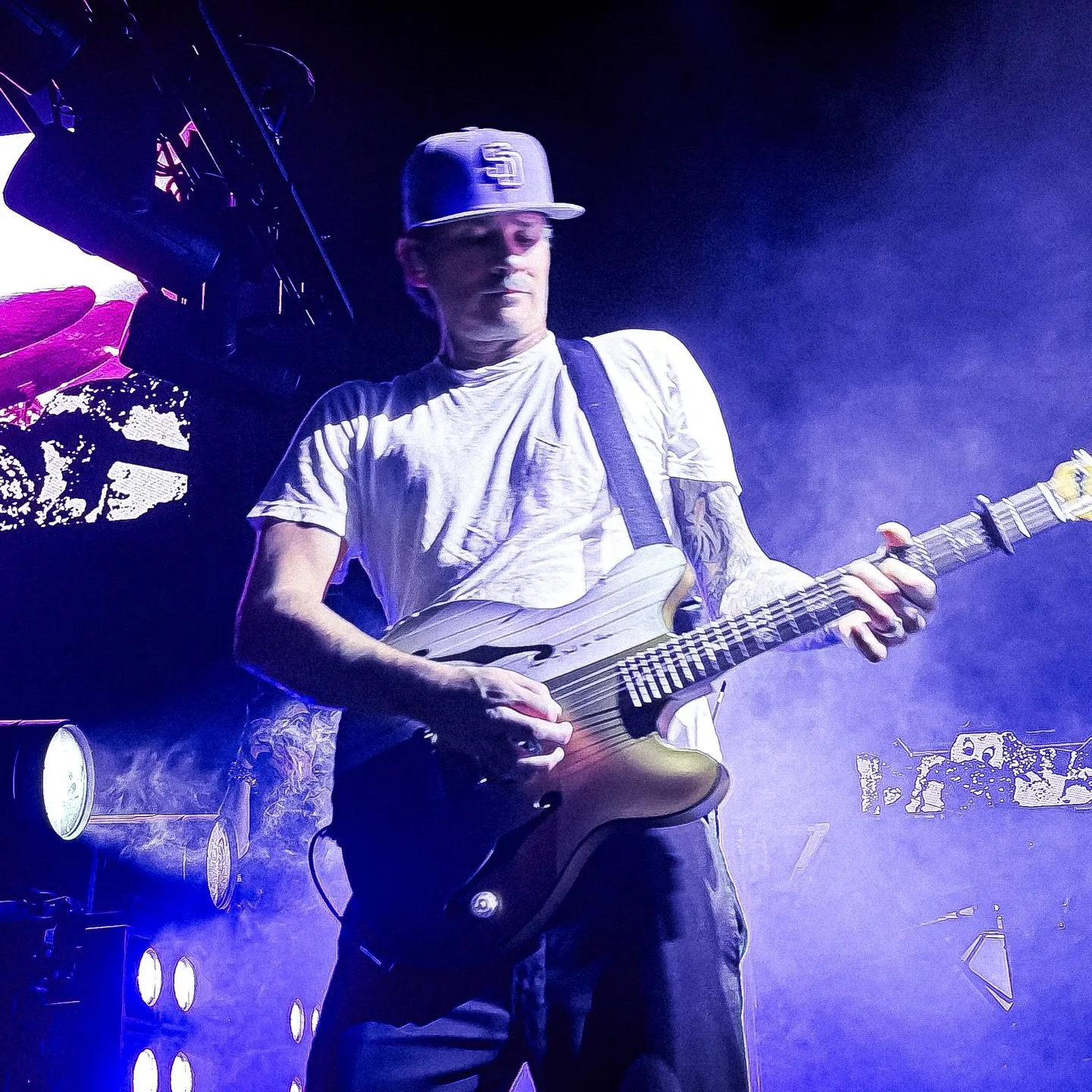 Tom DeLonge in blue stage light